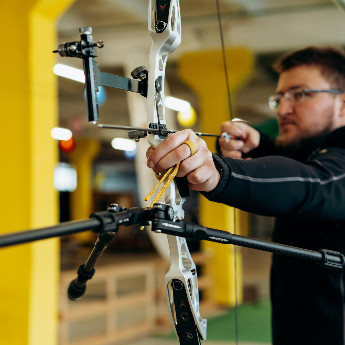 Archer at full draw weighing form and equipment choices