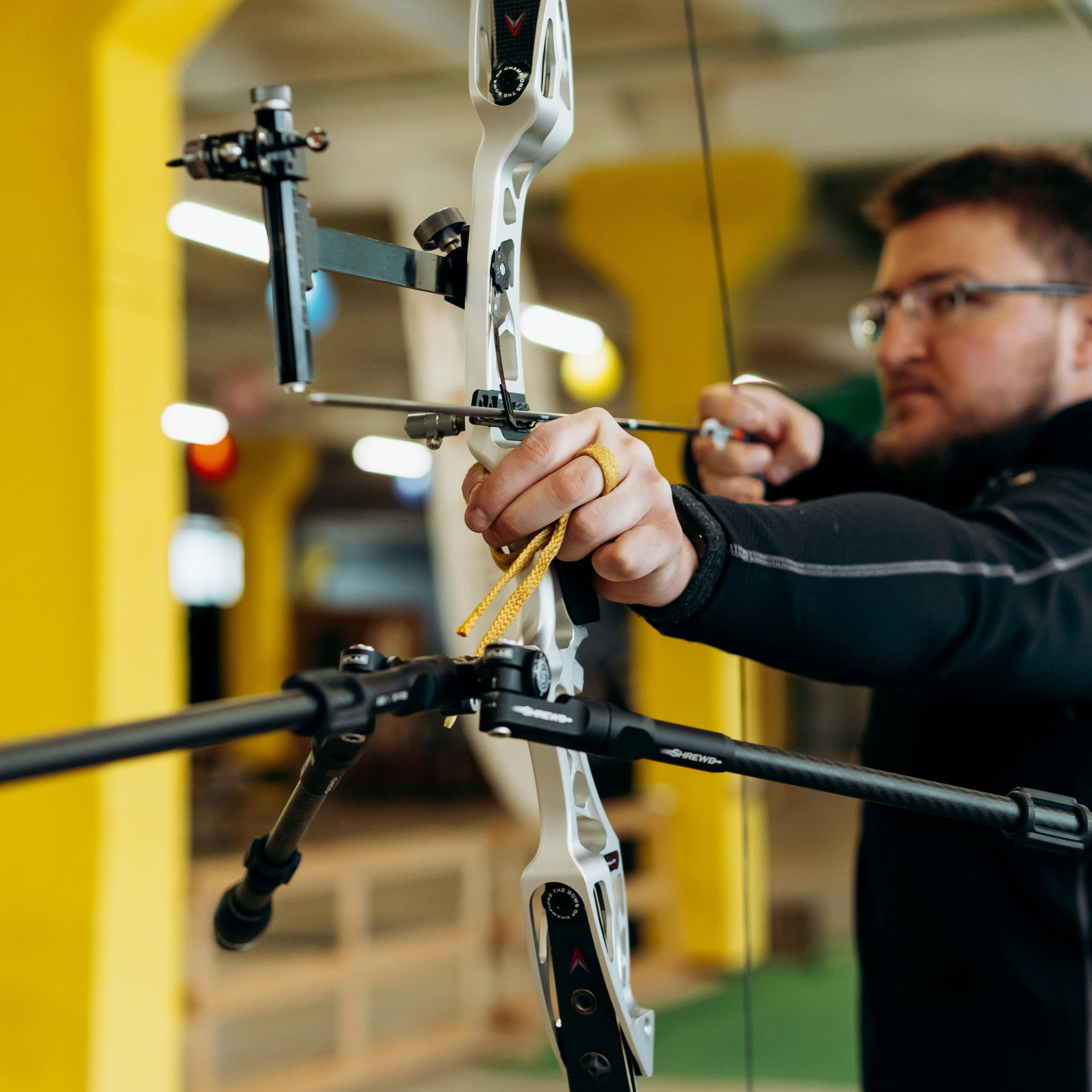 Archer at full draw weighing form and equipment choices
