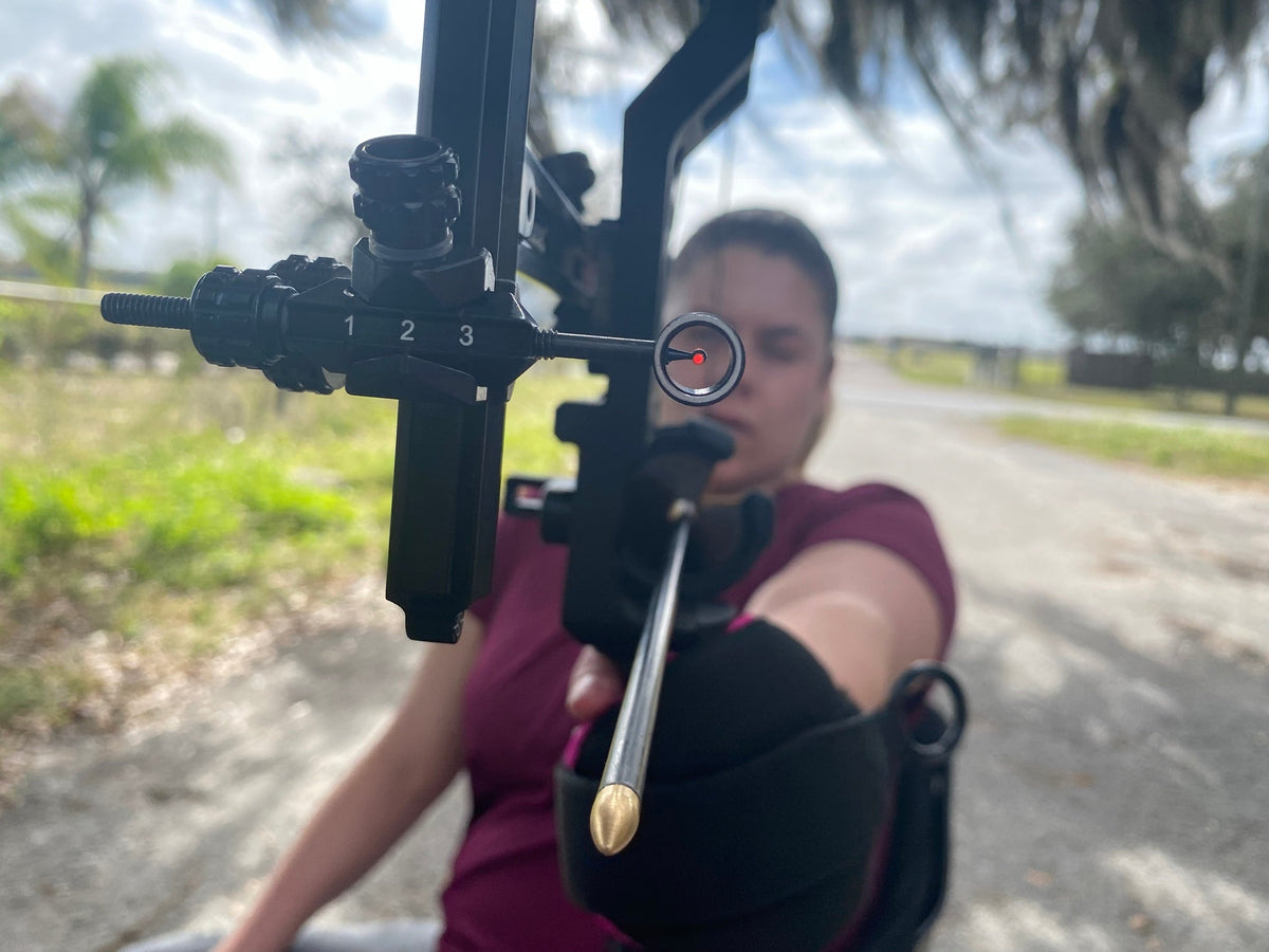 Tracy Otto at full draw, seen through her bow sight