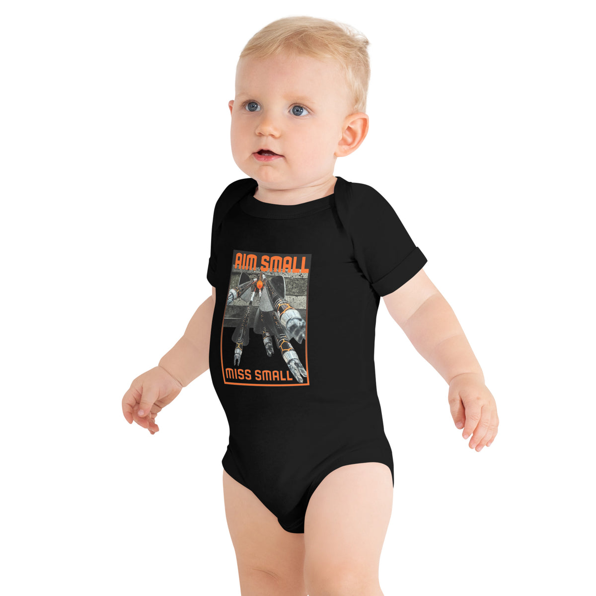 Aim Small Miss Small Baby Onesie in Black, worn by a standing baby