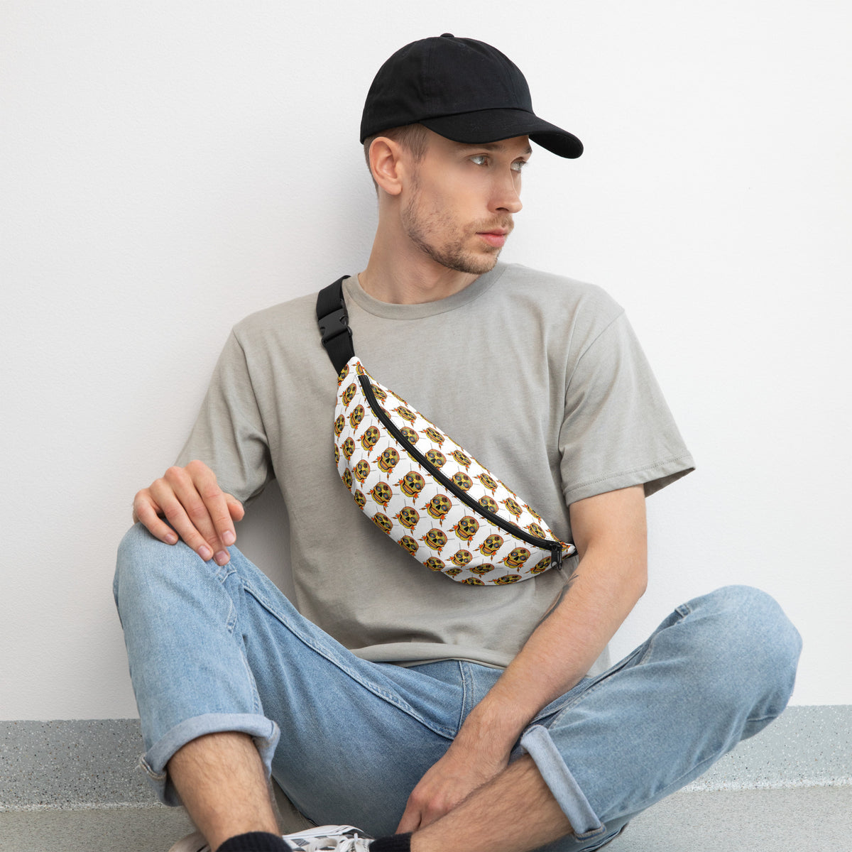 Sugar Skull Cross-Body Bag, worn by a seated model in a cap
