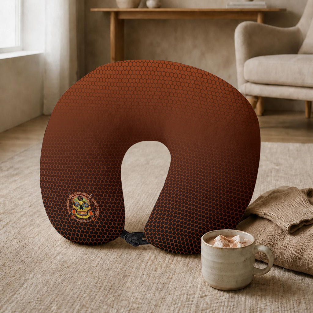 Sugar Skull Travel Neck Pillow, on the floor beside a mug