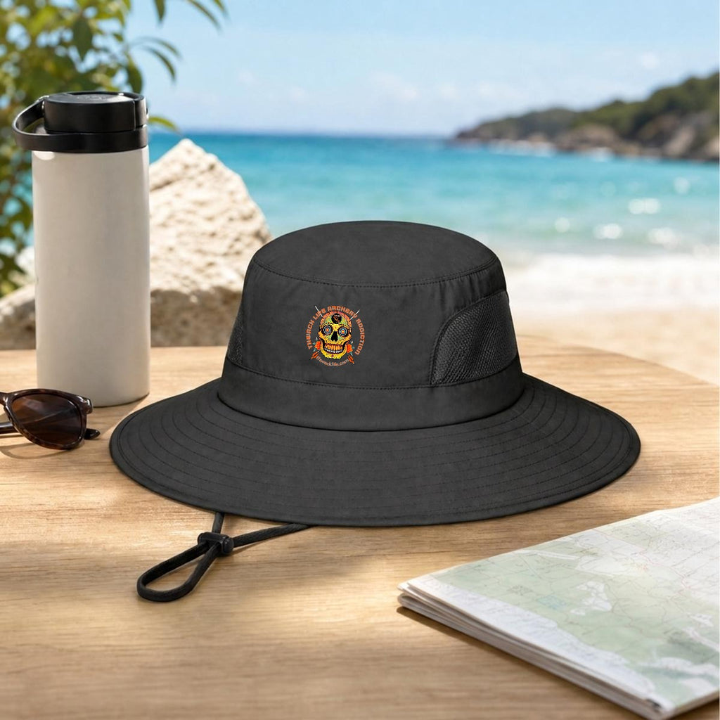Sugar Skull Wide Brim Sun Hat in Black, on a table by the beach