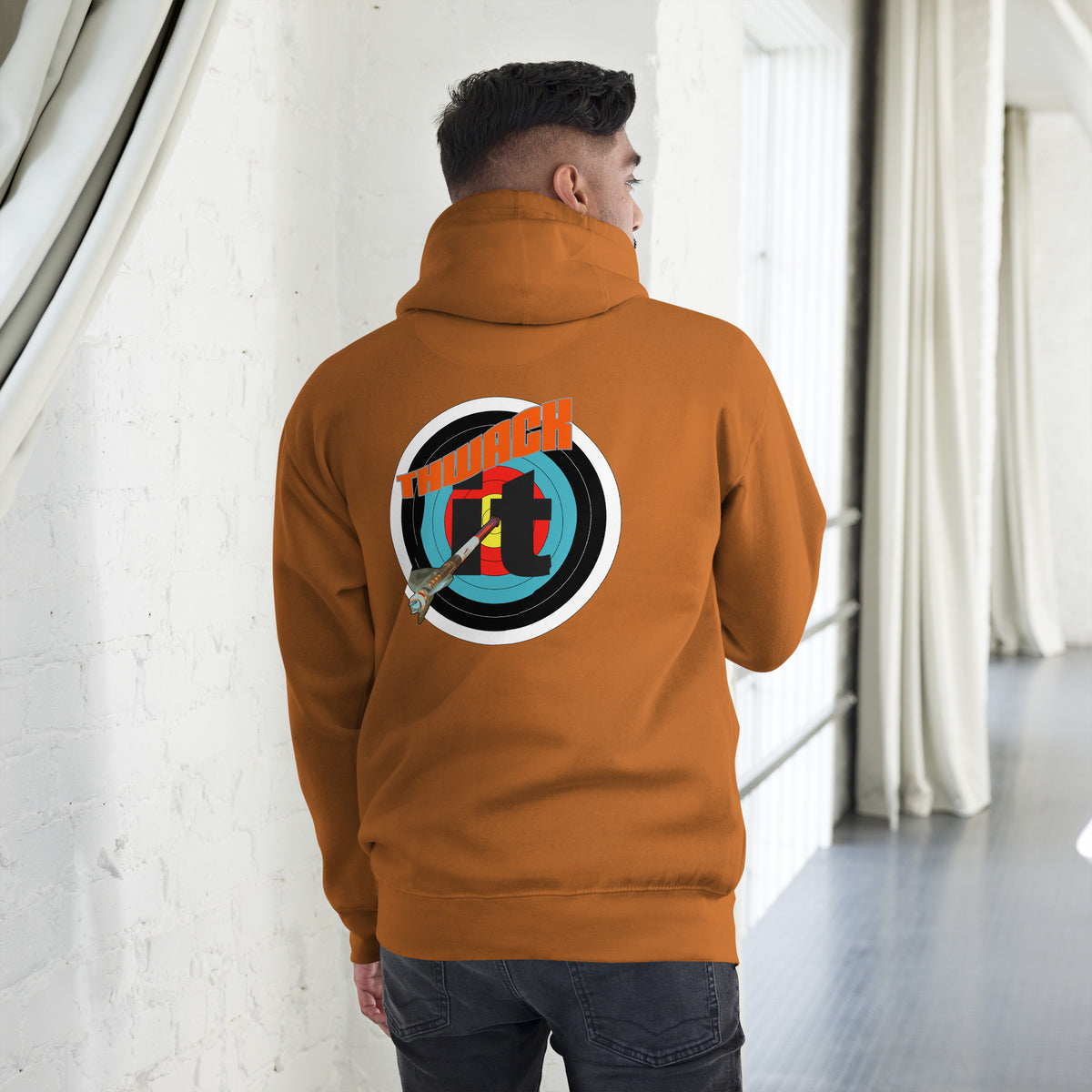 Thwack It Pullover Hoodie in Adobe, back view on a model showing the THWACK it target-and-arrow design