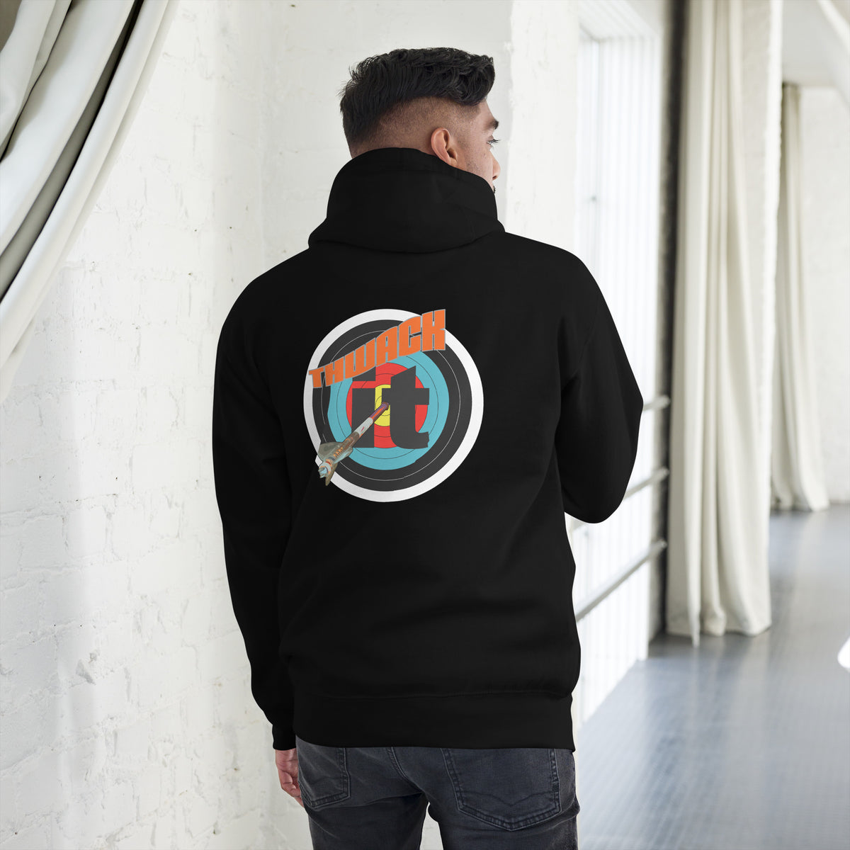 Thwack It Pullover Hoodie in Black, back view on a model showing the THWACK it target-and-arrow design