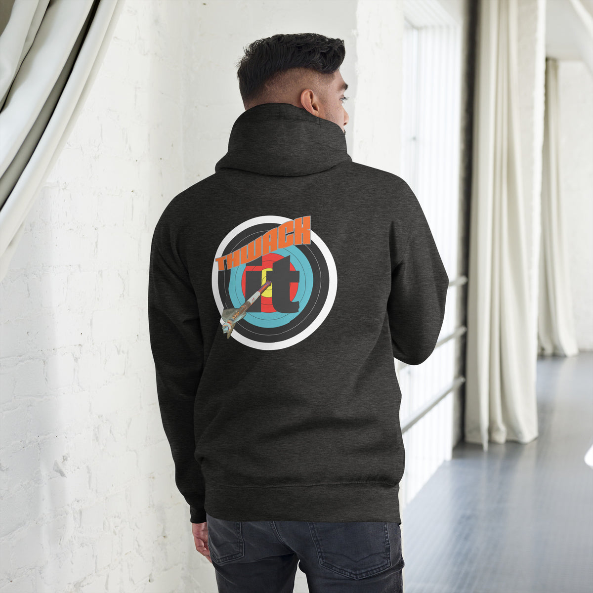 Thwack It Pullover Hoodie in Charcoal Heather, back view on a model showing the THWACK it target-and-arrow design