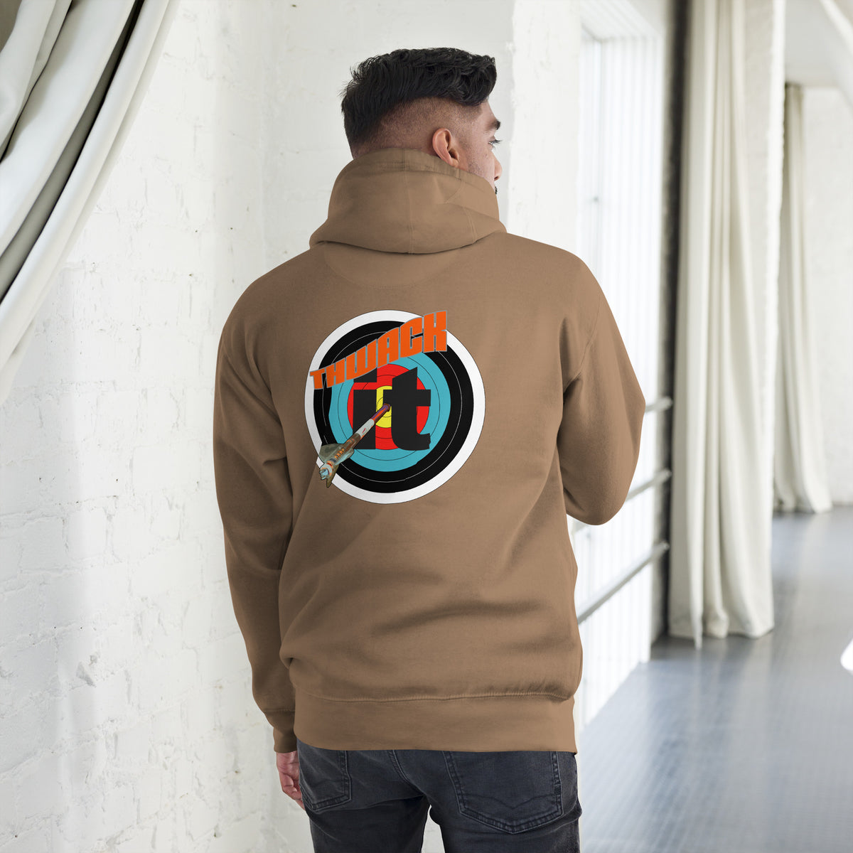 Thwack It Pullover Hoodie in Latte, back view on a model showing the THWACK it target-and-arrow design