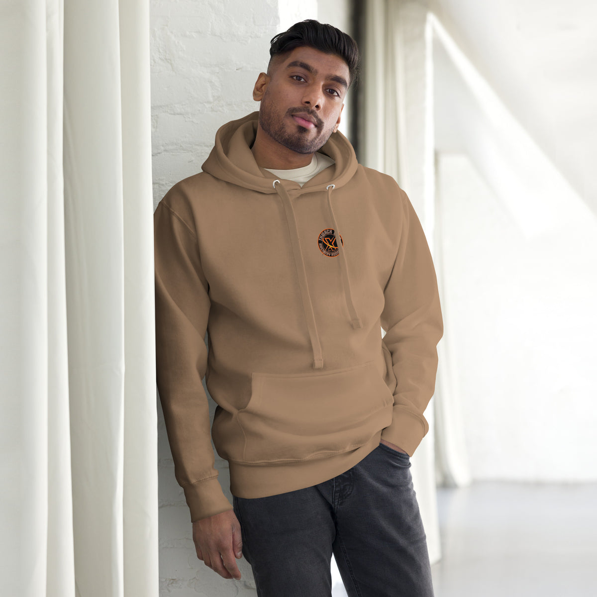 Thwack It Pullover Hoodie in Latte, front view on a model with the small round chest logo