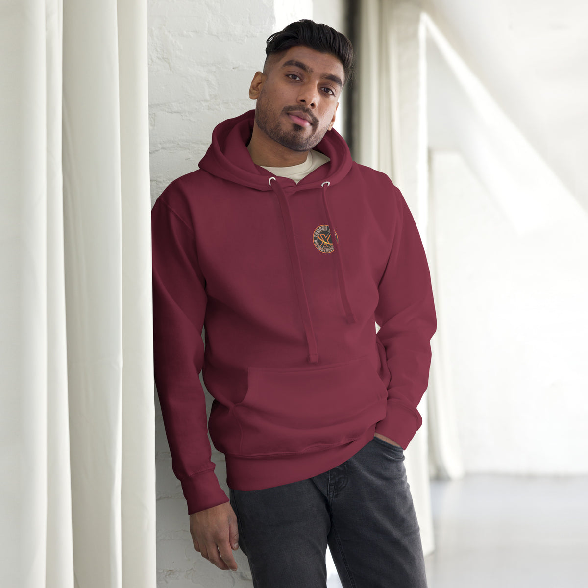 Thwack It Pullover Hoodie in Maroon, front view on a model with the small round chest logo