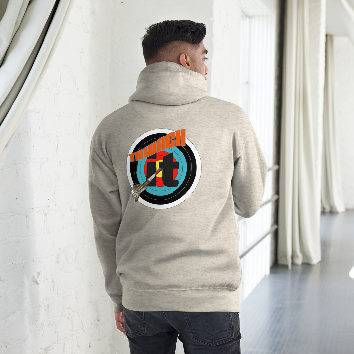 Thwack It Pullover Hoodie in Oatmeal Heather, back view on a model showing the THWACK it target-and-arrow design