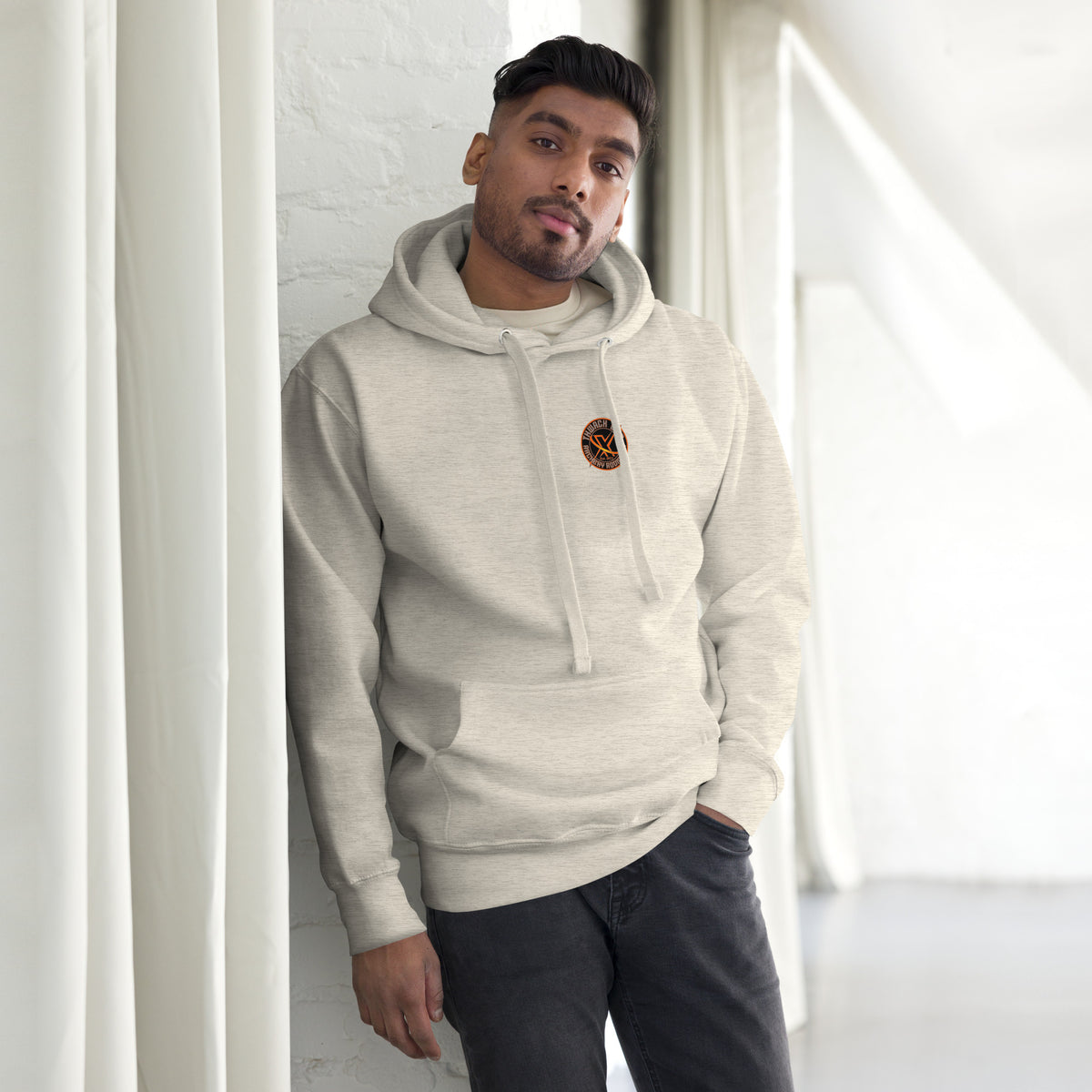 Thwack It Pullover Hoodie in Oatmeal Heather, front view on a model with the small round chest logo