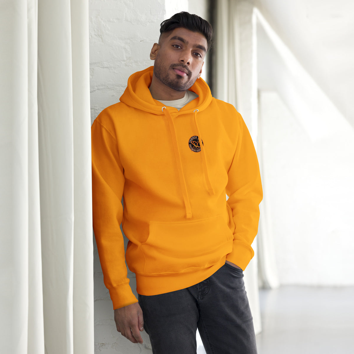 Thwack It Pullover Hoodie in Team Gold, front view on a model with the small round chest logo